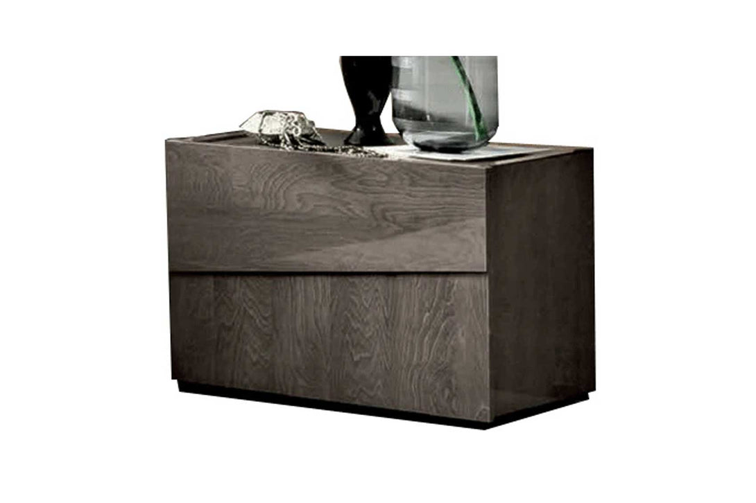 Modern nightstand with decorative items on a white background