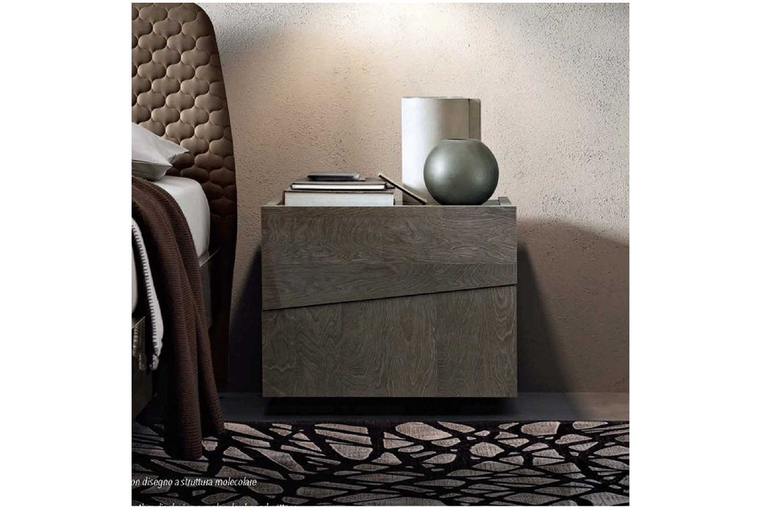 Modern nightstand with a lamp and books in a bedroom setting