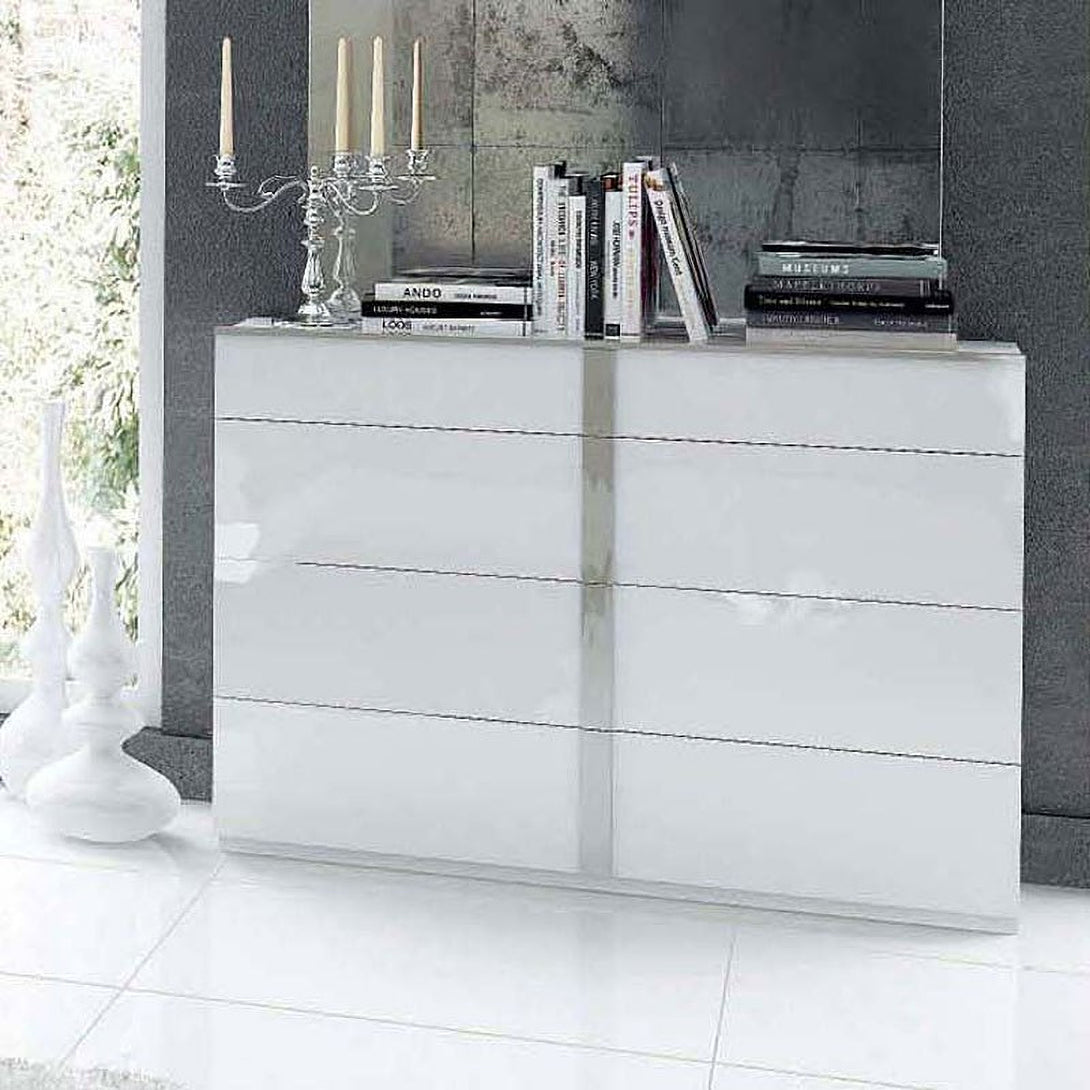 White dresser with decorative items against a gray wall