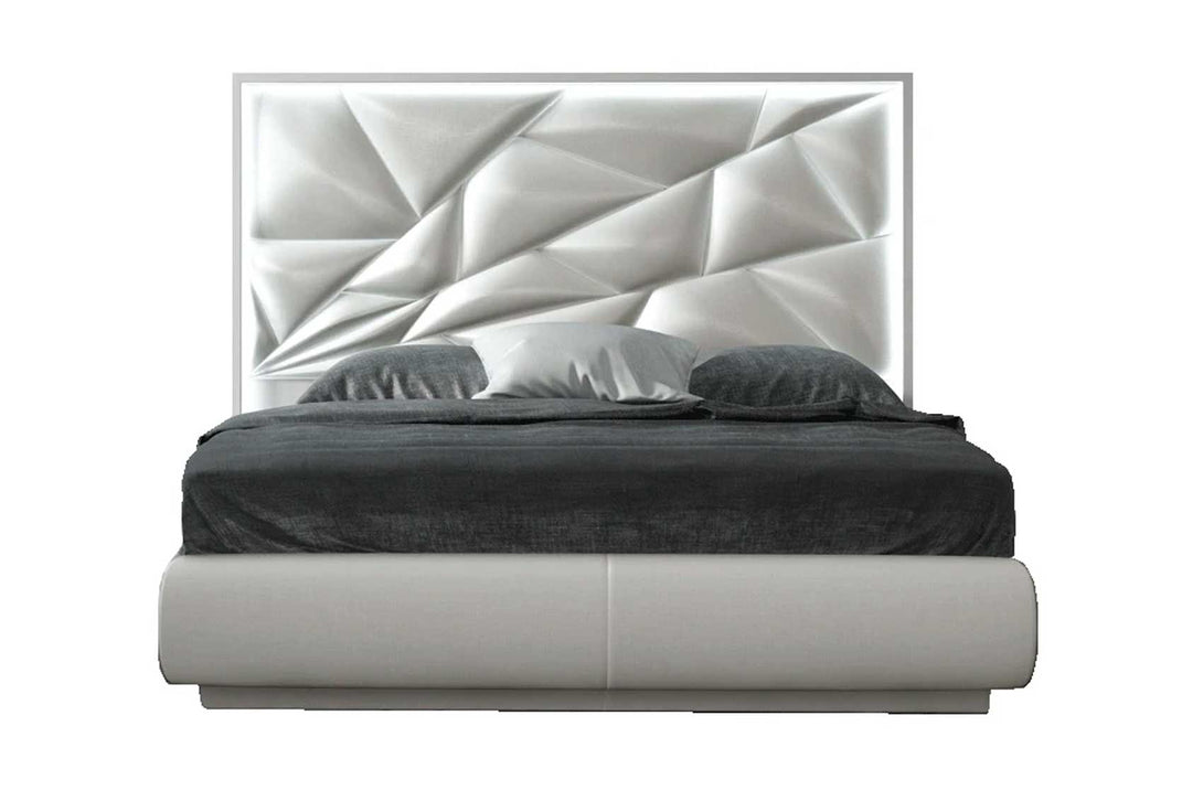 Modern bed with geometric headboard on a white background