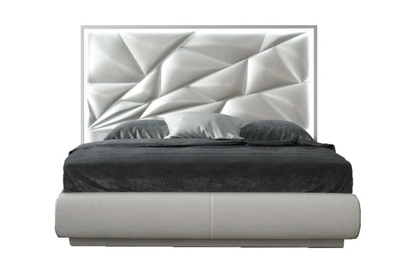 Modern bed with geometric headboard on a white background