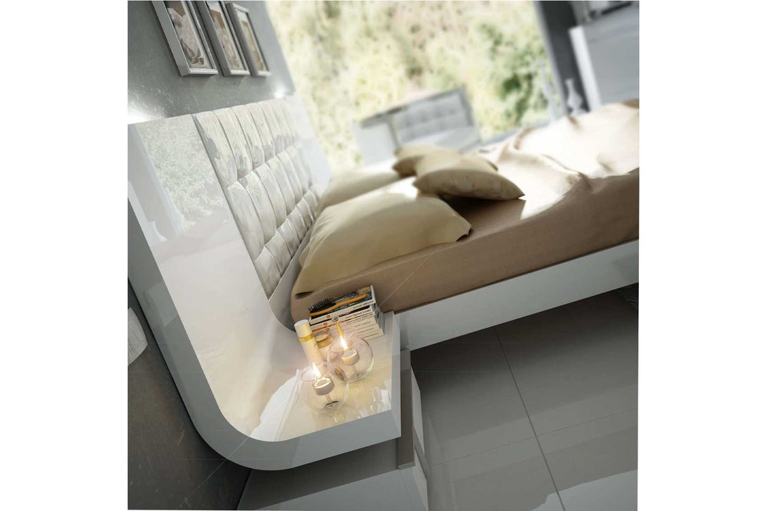 Modern bed with angled view of nightstand in a modern bedroom setting