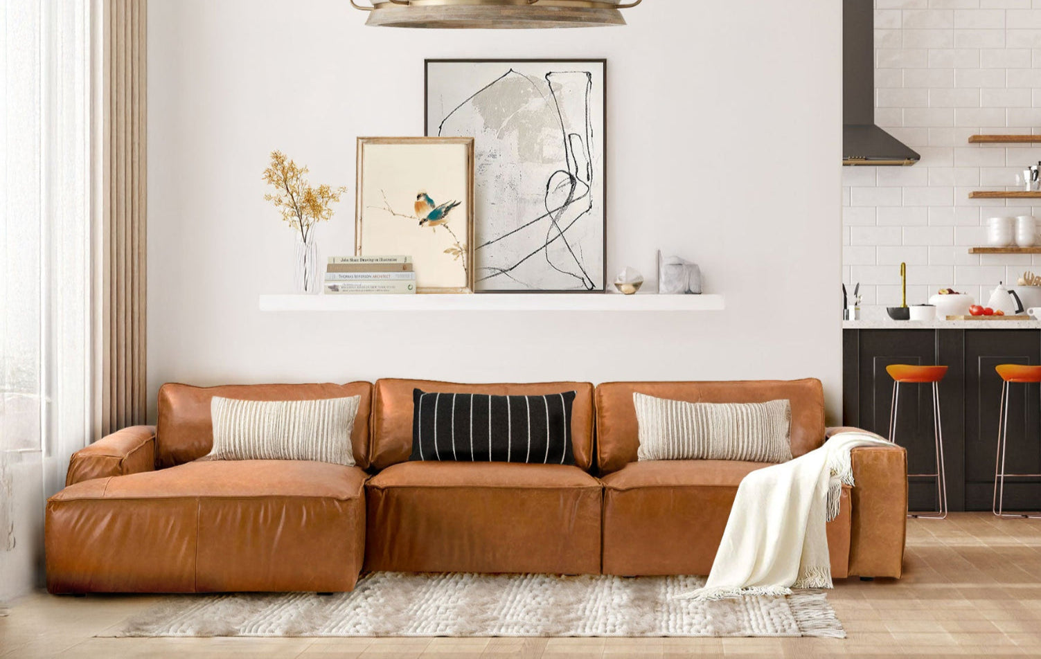 Modern living room with a brown sectional sofa, kitchen area, and decorative elements.