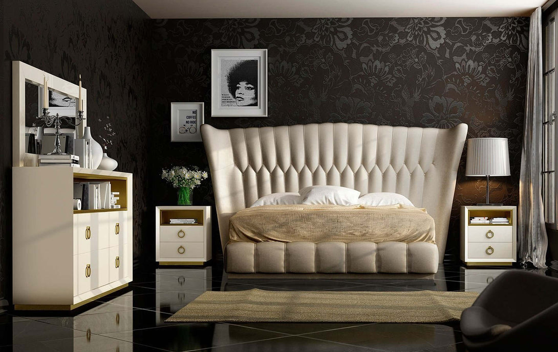 Modern bedroom with a large tufted bed, nightstands, and decorative elements.