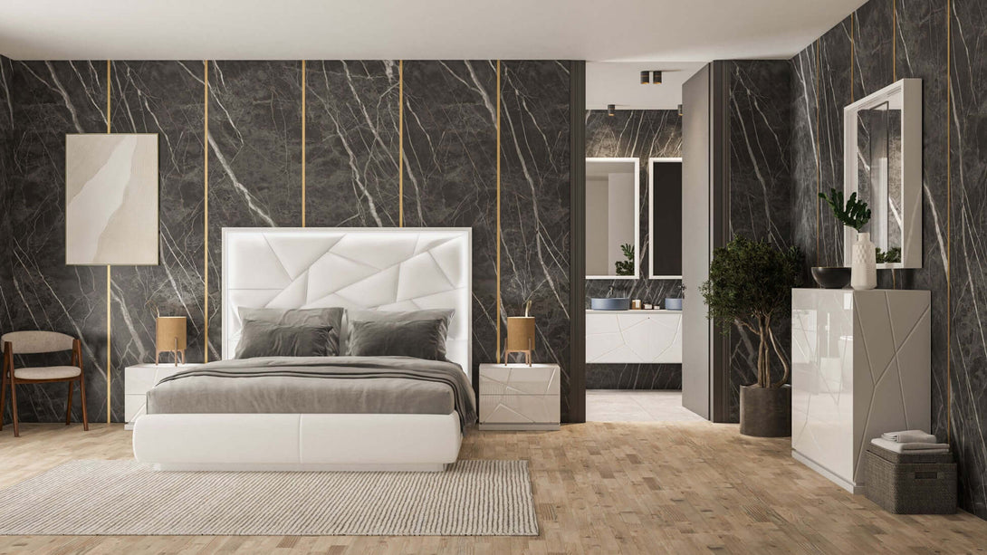 Modern bedroom with marble walls, a bed, and side tables.